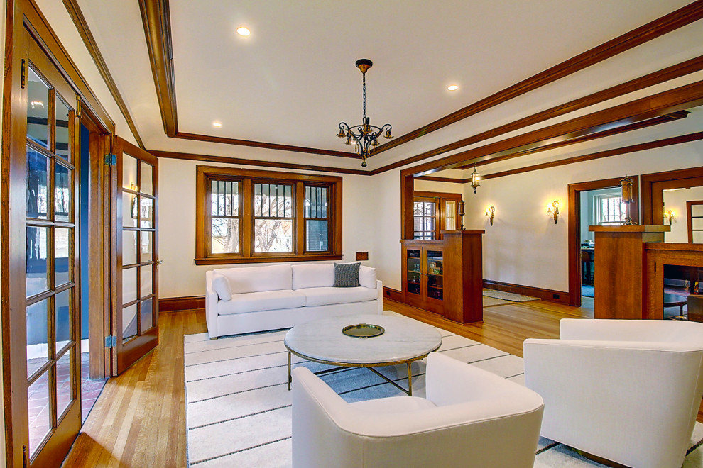 Photo of a large classic formal enclosed living room in Denver with white walls, light hardwood flooring, a standard fireplace, a tiled fireplace surround, brown floors and a coffered ceiling.