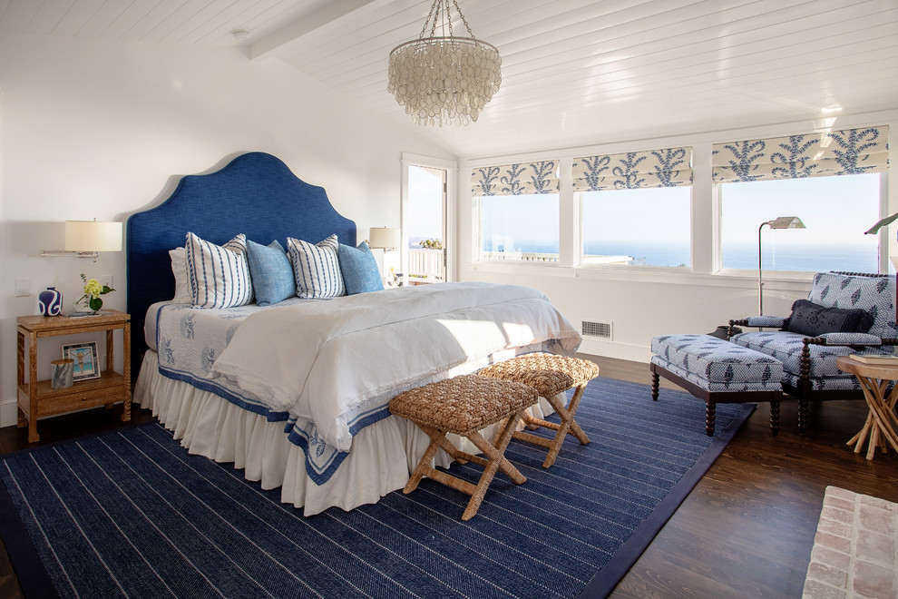 Inspiration for a mid-sized beach style master bedroom in Sacramento with white walls, dark hardwood floors, no fireplace and brown floor.