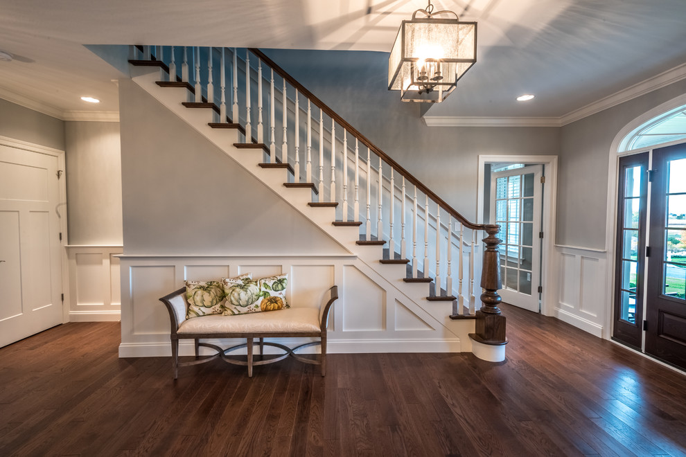 Inspiration for a large transitional medium tone wood floor foyer remodel with gray walls and a dark wood front door