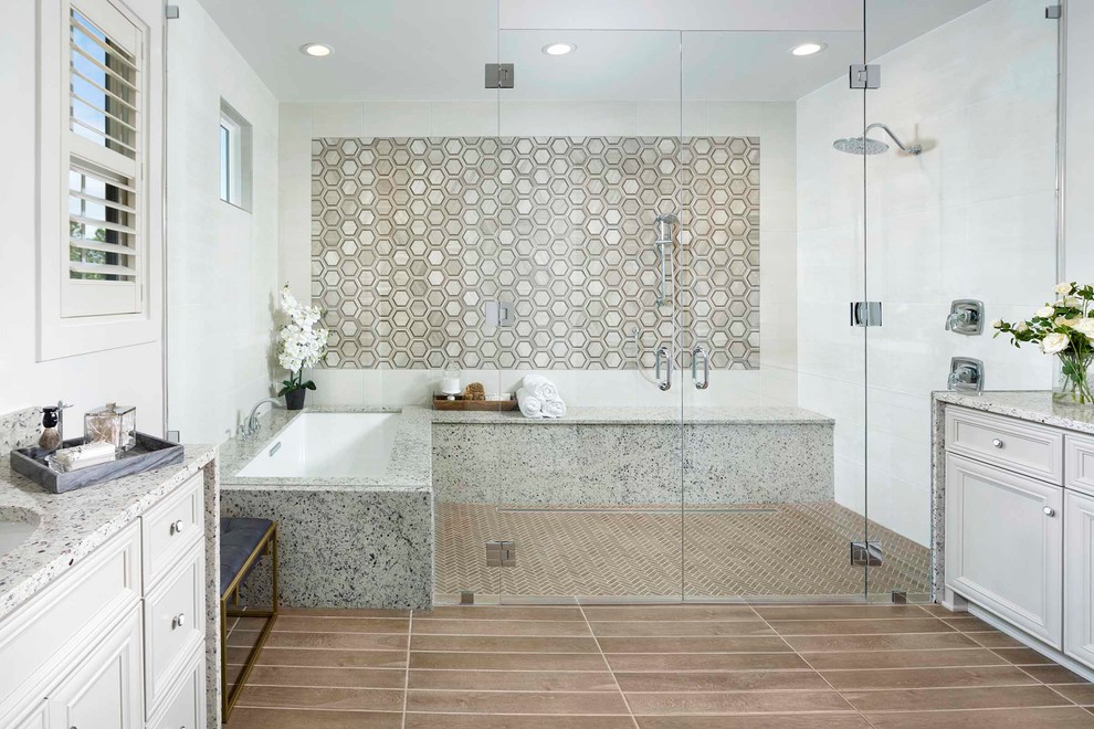 Inspiration for a transitional master bathroom in Charlotte with recessed-panel cabinets, white cabinets, an undermount tub, a curbless shower, multi-coloured tile, white tile, white walls, beige floor, a hinged shower door and multi-coloured benchtops.