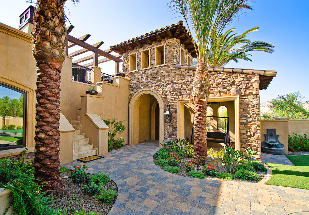 Photo of a large mediterranean two-storey beige exterior in Los Angeles.