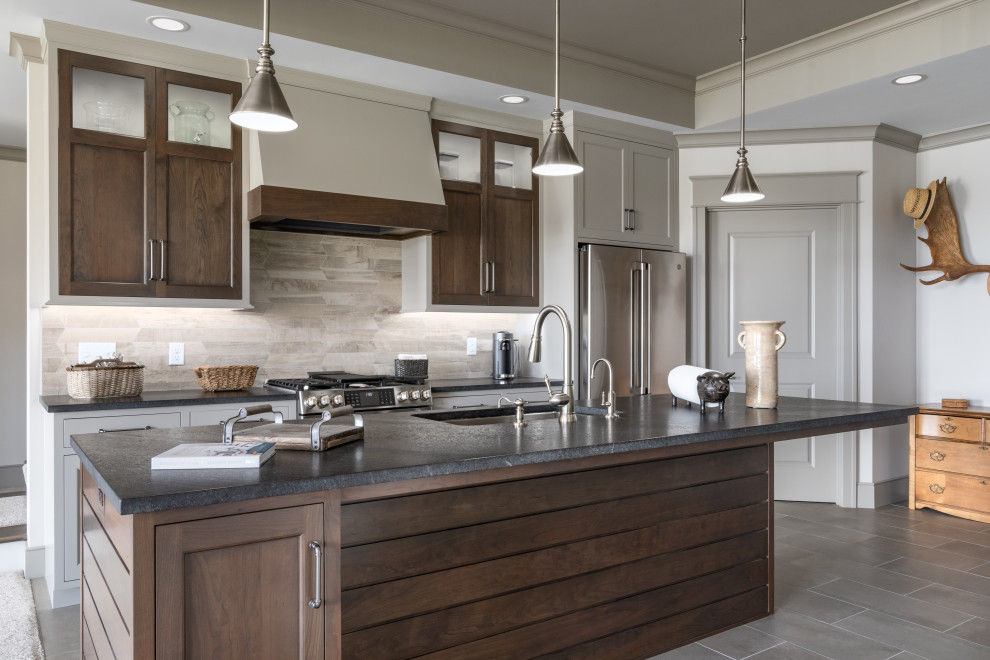 Expansive country kitchen pantry in Grand Rapids with grey cabinets, quartzite benchtops, grey splashback, limestone splashback, stainless steel appliances, dark hardwood floors, multiple islands, white benchtop and timber.