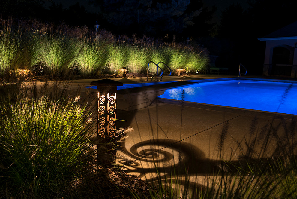 Example of a mid-sized backyard concrete and rectangular pool design
