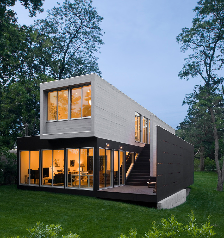Inspiration for a modern two-storey black exterior in Seattle with a flat roof.