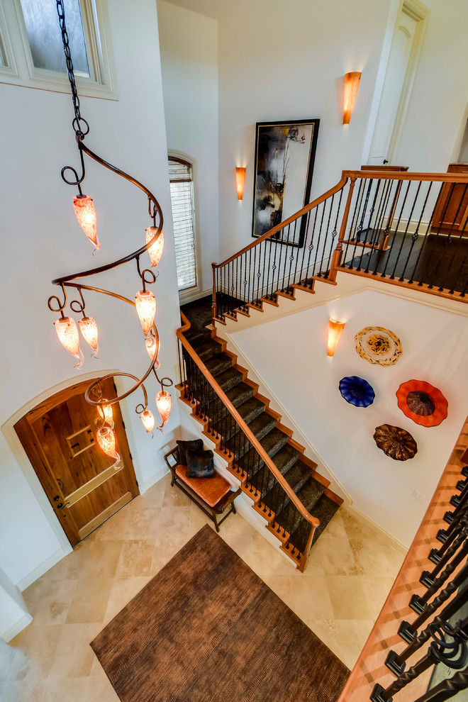 Example of a mid-sized transitional travertine floor foyer design in Austin with white walls and a medium wood front door