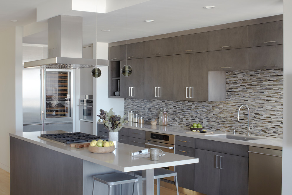 Inspiration for a contemporary galley kitchen in San Francisco with an undermount sink, flat-panel cabinets, grey cabinets, multi-coloured splashback, matchstick tile splashback, medium hardwood floors and with island.