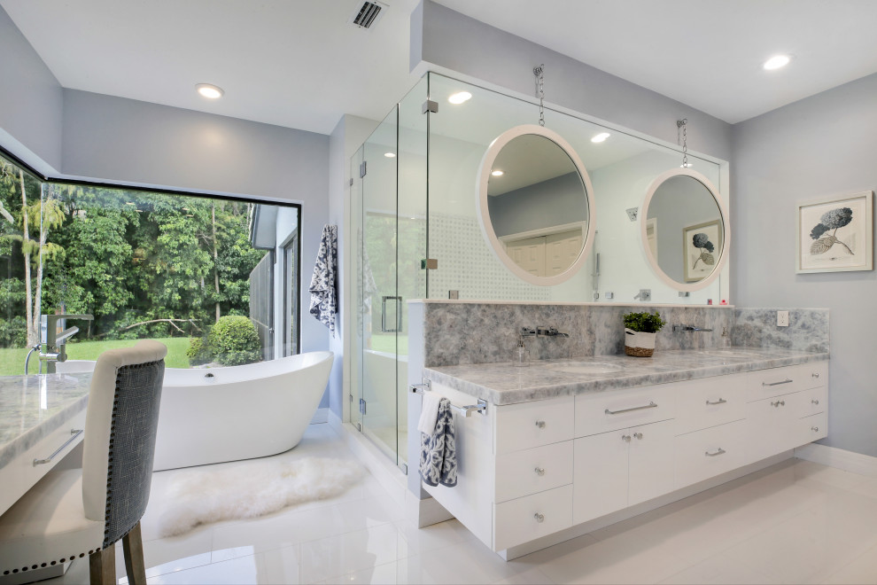 Mid-sized trendy master gray tile and marble tile marble floor, white floor and double-sink bathroom photo in Miami with flat-panel cabinets, white cabinets, a one-piece toilet, gray walls, an undermount sink, quartzite countertops, a hinged shower door, blue countertops and a built-in vanity