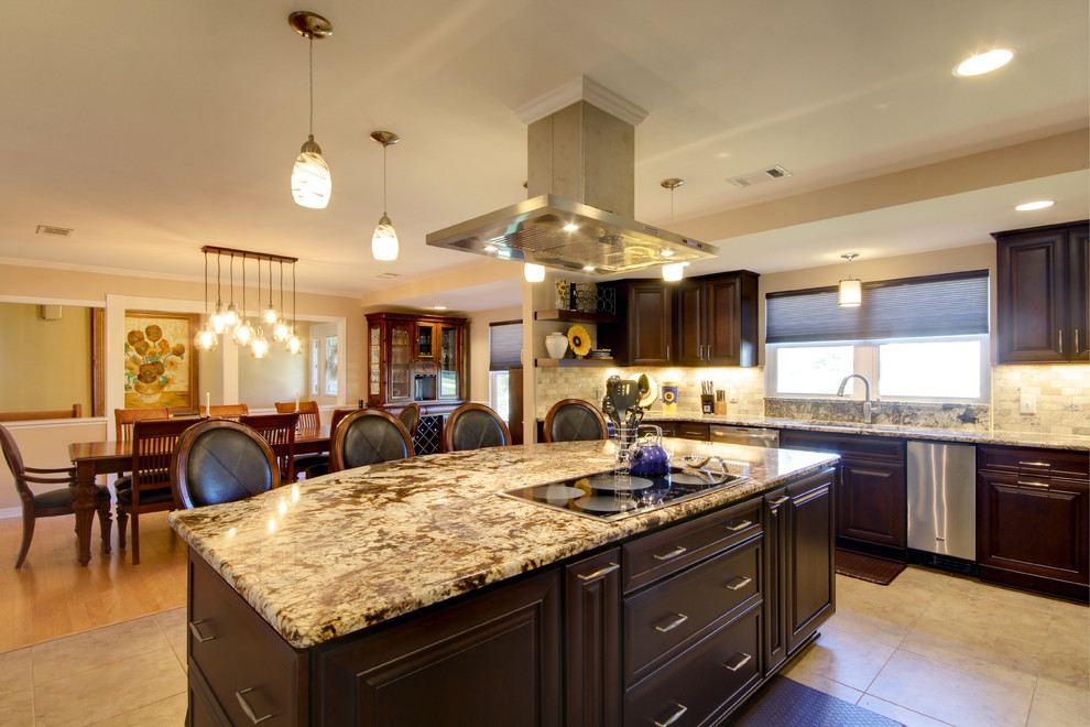Large transitional l-shaped porcelain tile eat-in kitchen photo in Miami with an undermount sink, raised-panel cabinets, dark wood cabinets, granite countertops, beige backsplash, stone tile backsplash, stainless steel appliances and an island