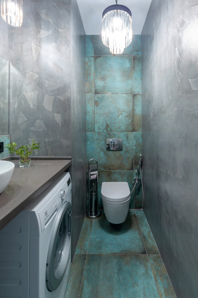 Inspiration for a contemporary powder room in Moscow with a wall-mount toilet, blue tile, grey walls, a vessel sink, blue floor and grey benchtops.