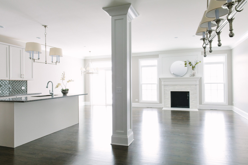 Eat-in kitchen - mid-sized transitional dark wood floor eat-in kitchen idea in Chicago with a single-bowl sink, shaker cabinets, white cabinets, granite countertops, black backsplash, glass tile backsplash, stainless steel appliances and an island
