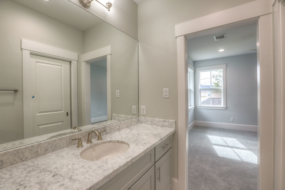 Example of a mid-sized transitional bathroom design in Houston with shaker cabinets, an undermount sink, gray cabinets and a one-piece toilet