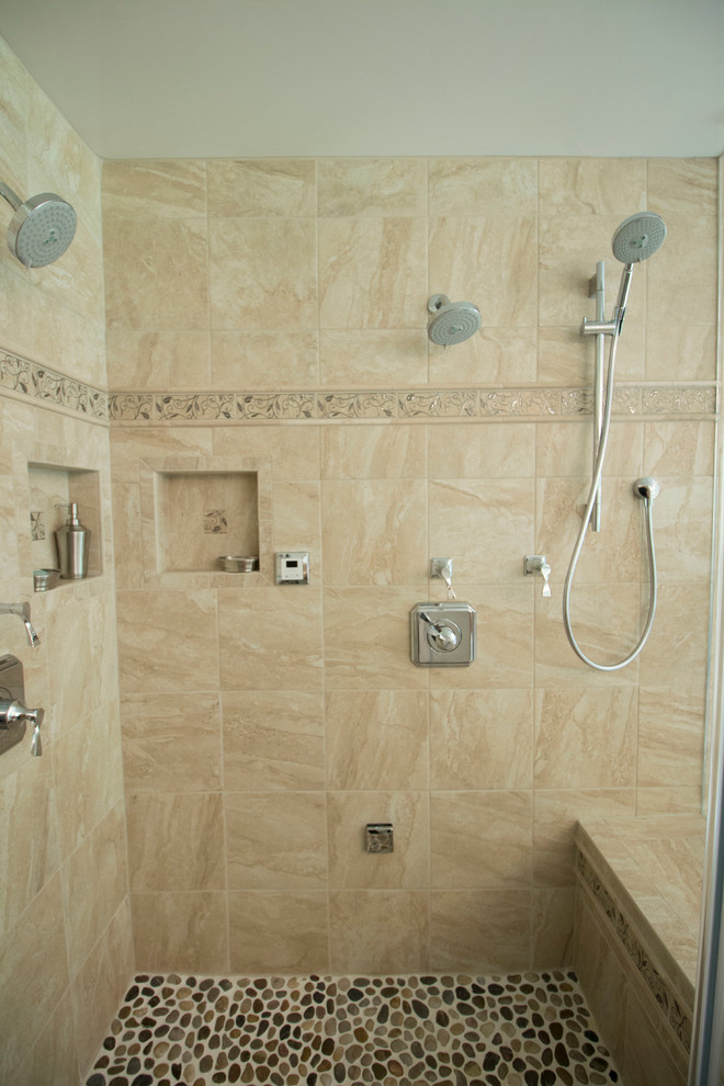 Drop-in bathtub - mid-sized transitional master beige tile and ceramic tile ceramic tile drop-in bathtub idea with an undermount sink, flat-panel cabinets, light wood cabinets, solid surface countertops, a two-piece toilet and beige walls