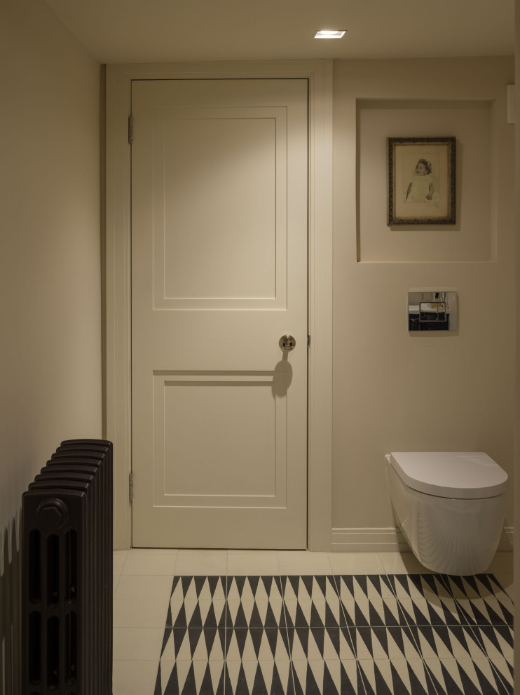Mid-sized contemporary powder room in London with a wall-mount toilet, cement tiles and beige floor.