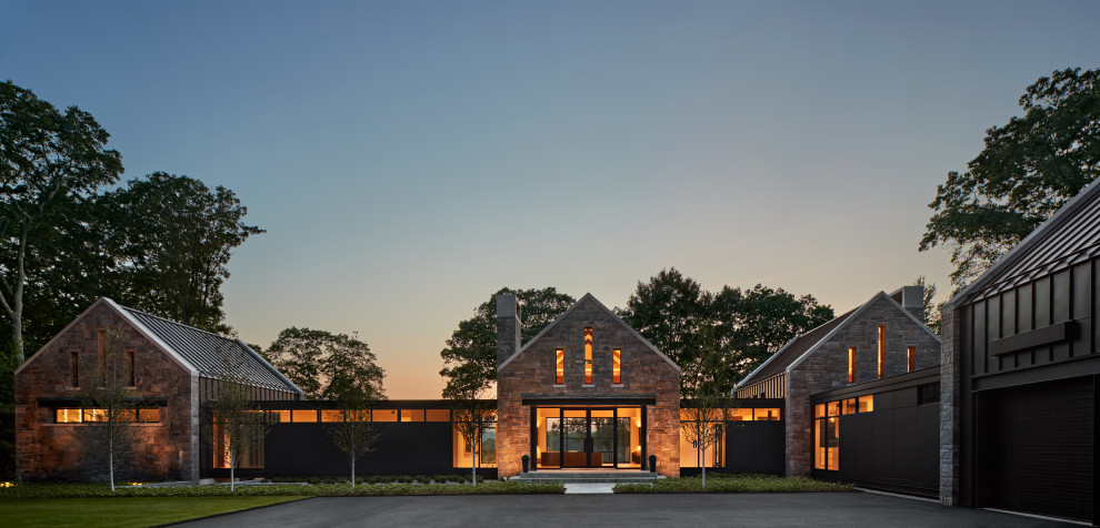 Aménagement d'une façade de maison grise contemporaine en pierre de taille moyenne et de plain-pied avec un toit plat et un toit en métal.