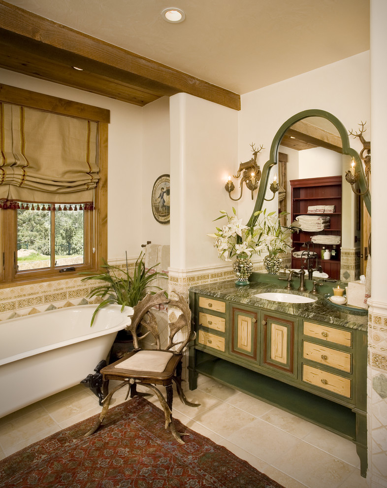 Photo of a country bathroom in Tampa with green cabinets, a claw-foot tub, white walls, an undermount sink, beige floor, green benchtops and raised-panel cabinets.