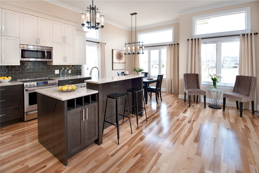 This is an example of a contemporary kitchen in Ottawa with stainless steel appliances and subway tile splashback.