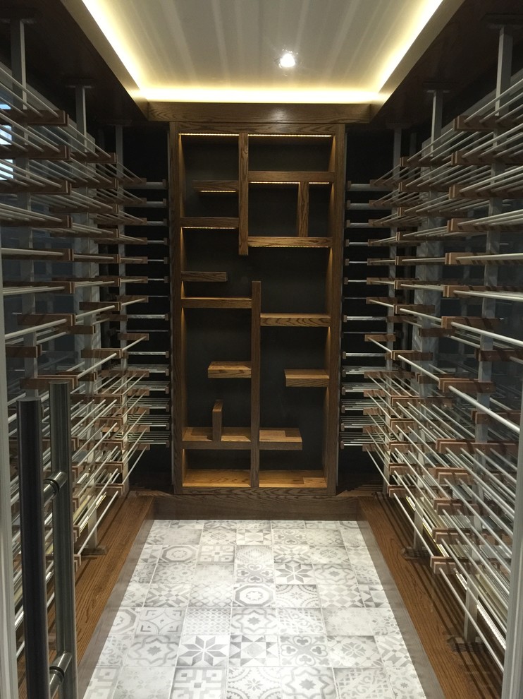 Mid-sized contemporary wine cellar in Toronto with ceramic floors, storage racks and white floor.