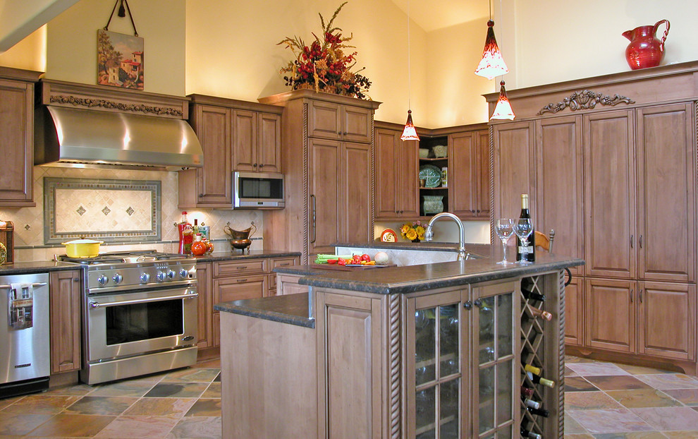 Inspiration for a large mediterranean u-shaped open plan kitchen in San Luis Obispo with raised-panel cabinets, distressed cabinets, tile benchtops, green splashback, stone tile splashback, panelled appliances, slate floors and with island.