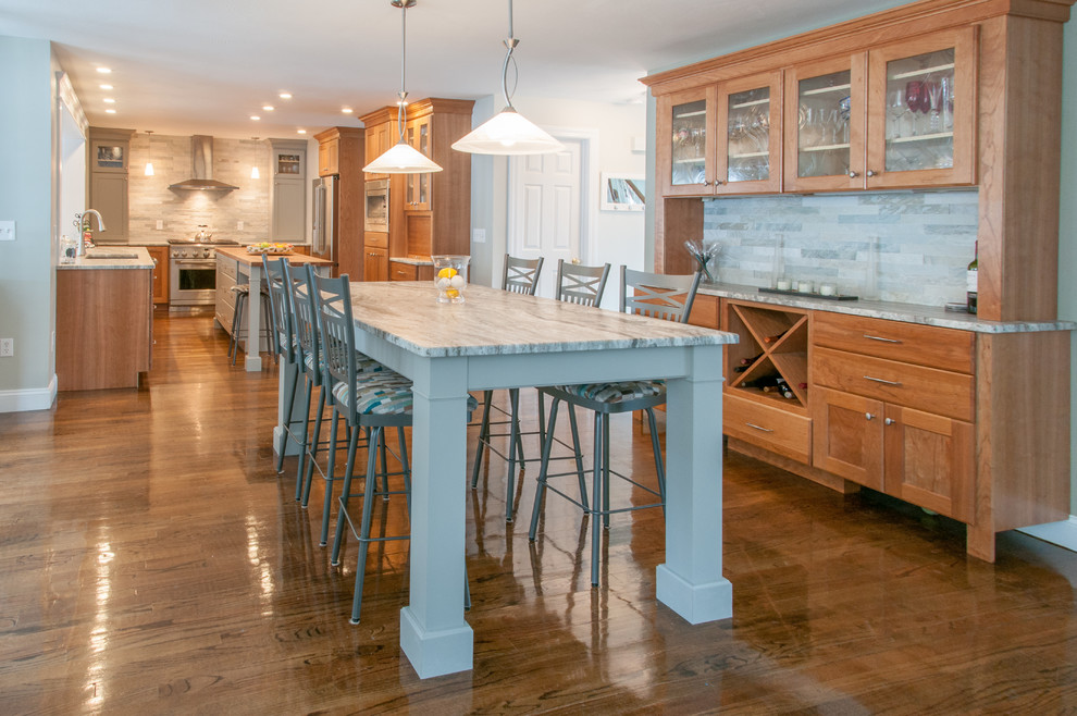 Large transitional single-wall medium tone wood floor and brown floor eat-in kitchen photo in Boston with granite countertops, an island, an integrated sink, light wood cabinets, stainless steel appliances, flat-panel cabinets, green backsplash and stone tile backsplash