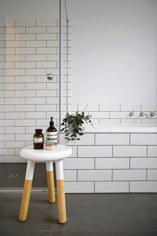 This is an example of a large traditional kids bathroom in Melbourne with shaker cabinets, white cabinets, wood benchtops, a drop-in tub, a corner shower, a one-piece toilet, gray tile, ceramic tile, white walls and porcelain floors.