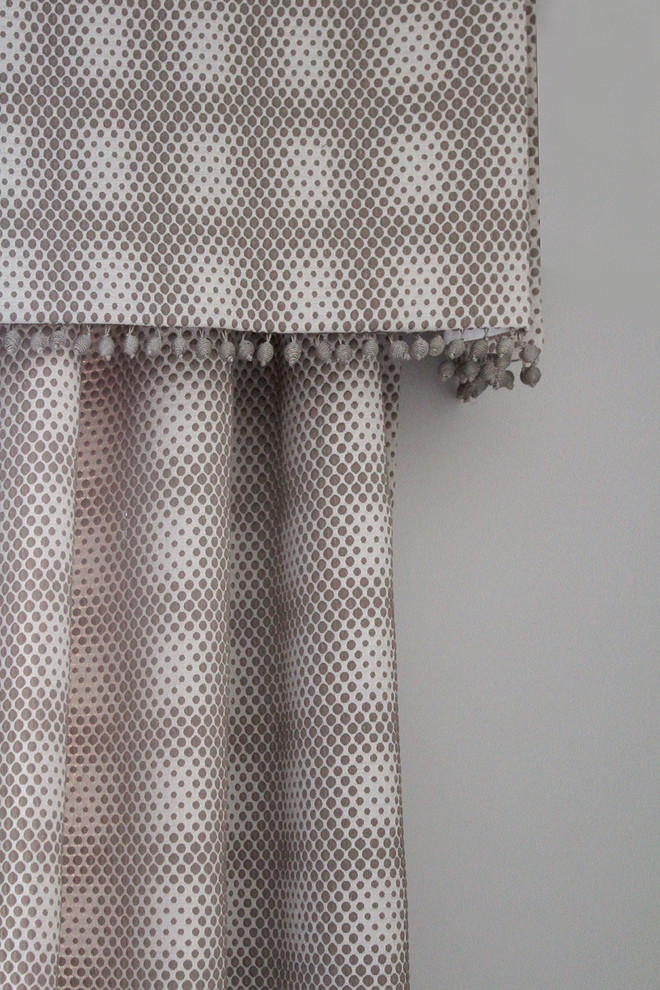 Traditional Rumson Home - Window treatment detail of a soft valence top treatment with beaded tassel fringe and matching geometric drapery panels.