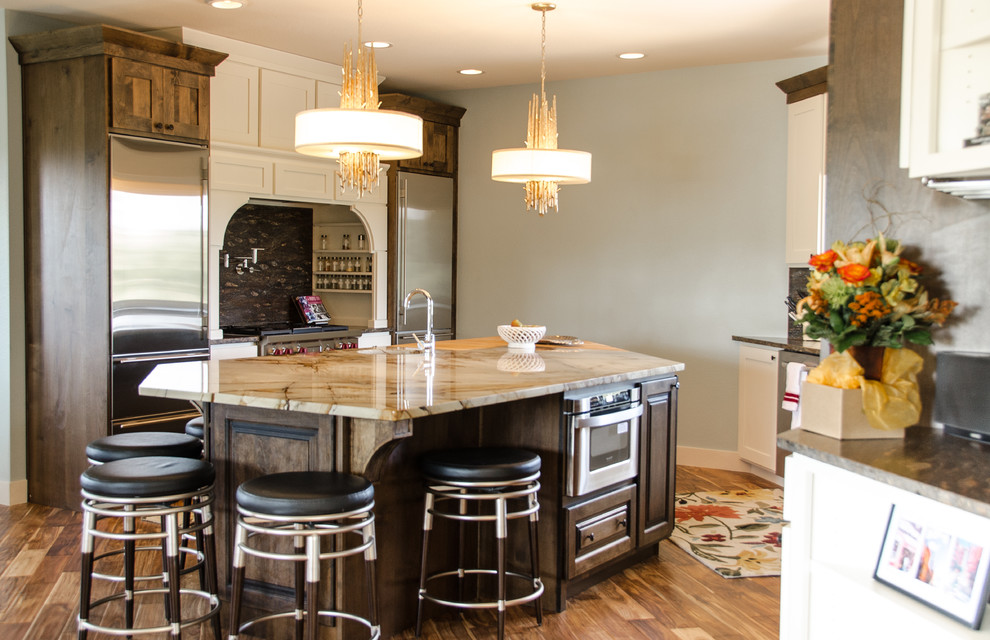 Eat-in kitchen - large transitional single-wall medium tone wood floor eat-in kitchen idea in Denver with a single-bowl sink, dark wood cabinets, quartzite countertops, brown backsplash, stainless steel appliances, an island and raised-panel cabinets