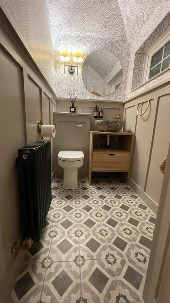 Inspiration for a small classic cloakroom in Surrey with open cabinets, light wood cabinets, a one-piece toilet, ceramic flooring, wooden worktops, grey floors, a freestanding vanity unit, a vaulted ceiling and panelled walls.
