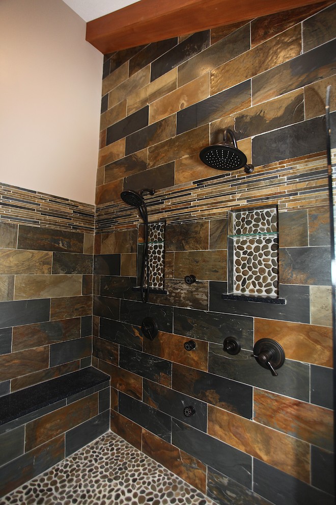 Freestanding bathtub - large rustic master slate tile brown floor freestanding bathtub idea in Indianapolis with brown cabinets, beige walls and an undermount sink