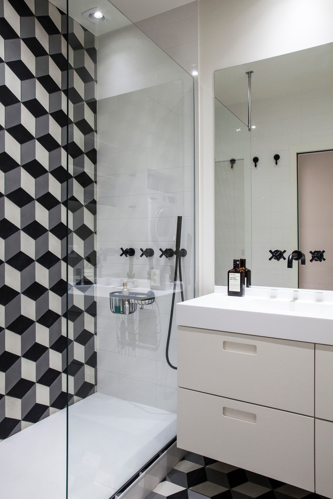 Design ideas for a contemporary 3/4 bathroom in Paris with flat-panel cabinets, white cabinets, black and white tile, an integrated sink, grey floor and white benchtops.