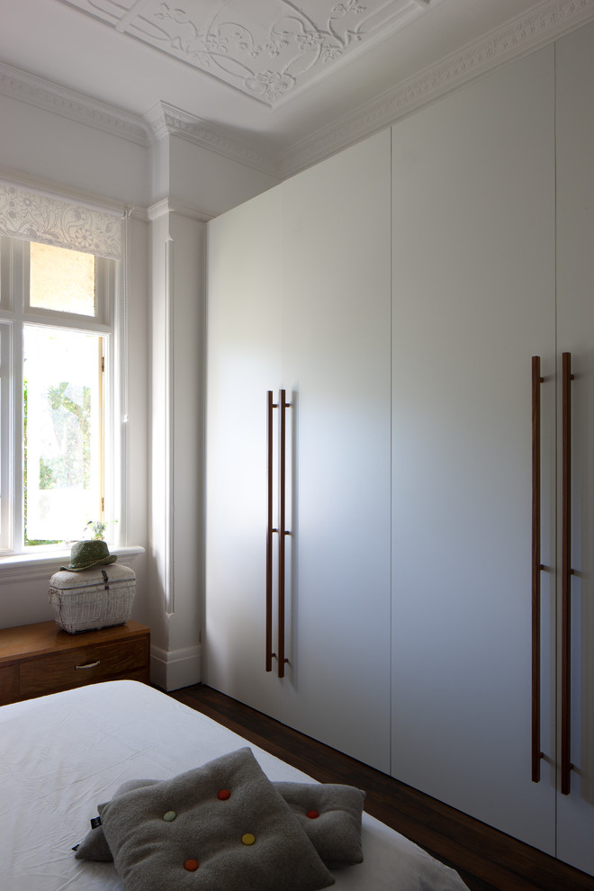 This is an example of a small eclectic master bedroom in Sydney with white walls.