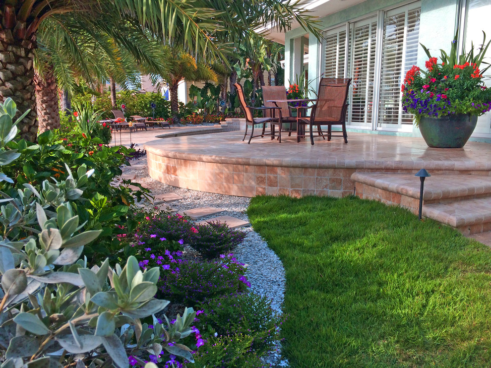 Backyard transformation features a new Travertine deck Beach Style