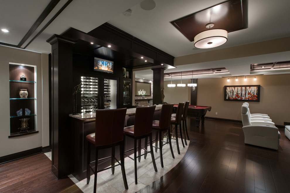 This is an example of a large contemporary galley seated home bar in Ottawa with shaker cabinets, dark wood cabinets, granite benchtops and dark hardwood floors.