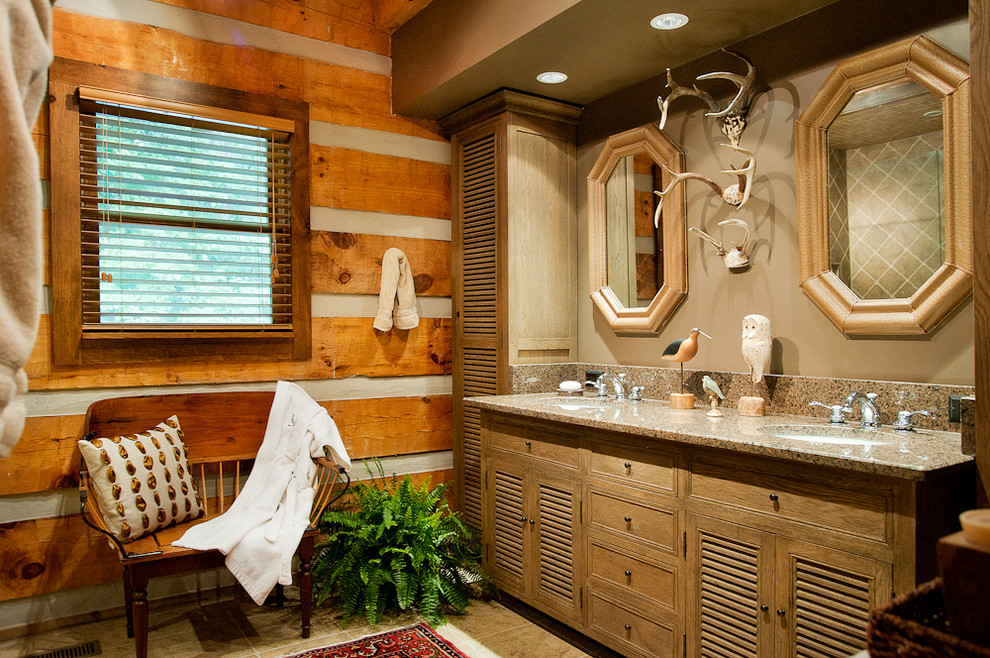 Photo of a mid-sized traditional bathroom in Nashville with a vessel sink, medium wood cabinets, granite benchtops, a double shower, a two-piece toilet, brown tile, brown walls, porcelain floors and louvered cabinets.