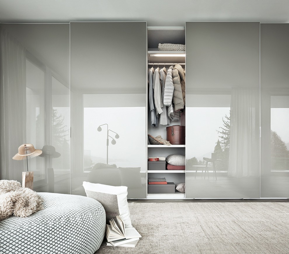 Design ideas for a contemporary gender-neutral built-in wardrobe in Catania-Palermo with flat-panel cabinets and grey cabinets.