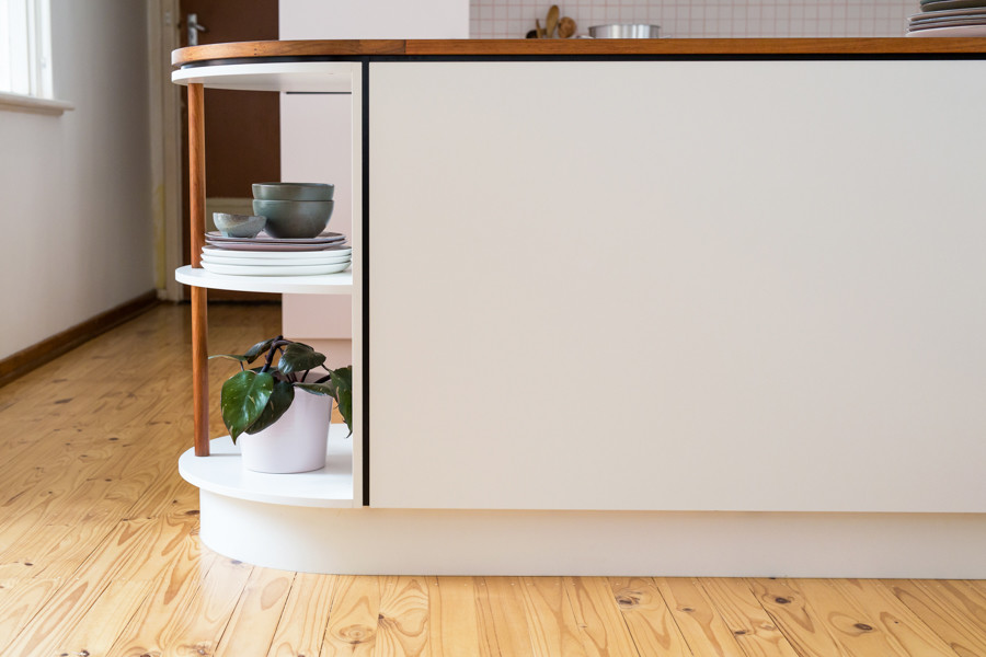 Design ideas for a small midcentury u-shaped open plan kitchen in Adelaide with flat-panel cabinets, laminate benchtops, white splashback, ceramic splashback, white appliances and light hardwood floors.