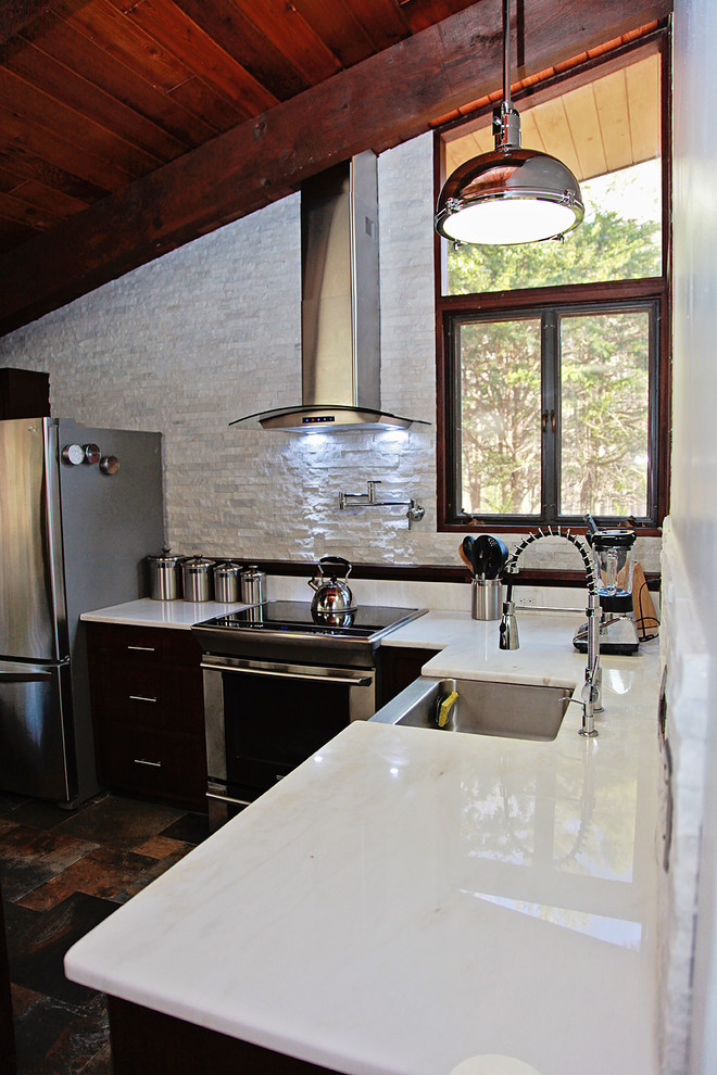 Large transitional u-shaped kitchen in Boston with stainless steel appliances and porcelain floors.