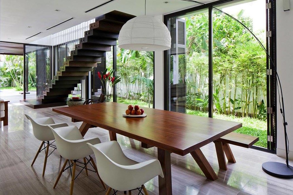 Large tropical open plan dining in Other with white walls and no fireplace.