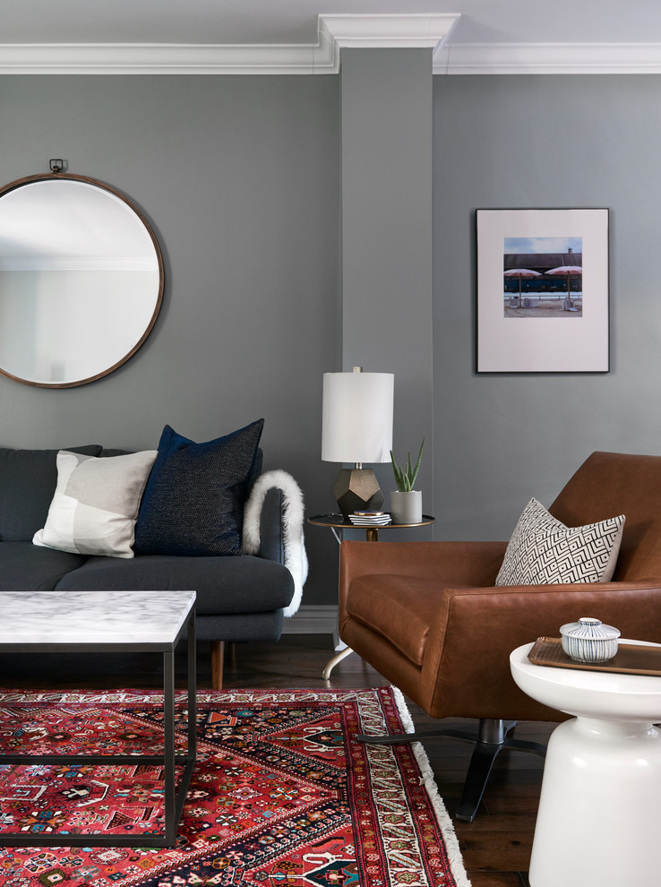 Small midcentury open concept family room in Toronto with grey walls and dark hardwood floors.