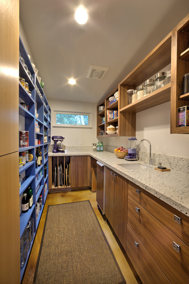 Inspiration for a small modern galley kitchen pantry in Sacramento with medium wood cabinets, quartz benchtops, concrete floors, an undermount sink, open cabinets and panelled appliances.