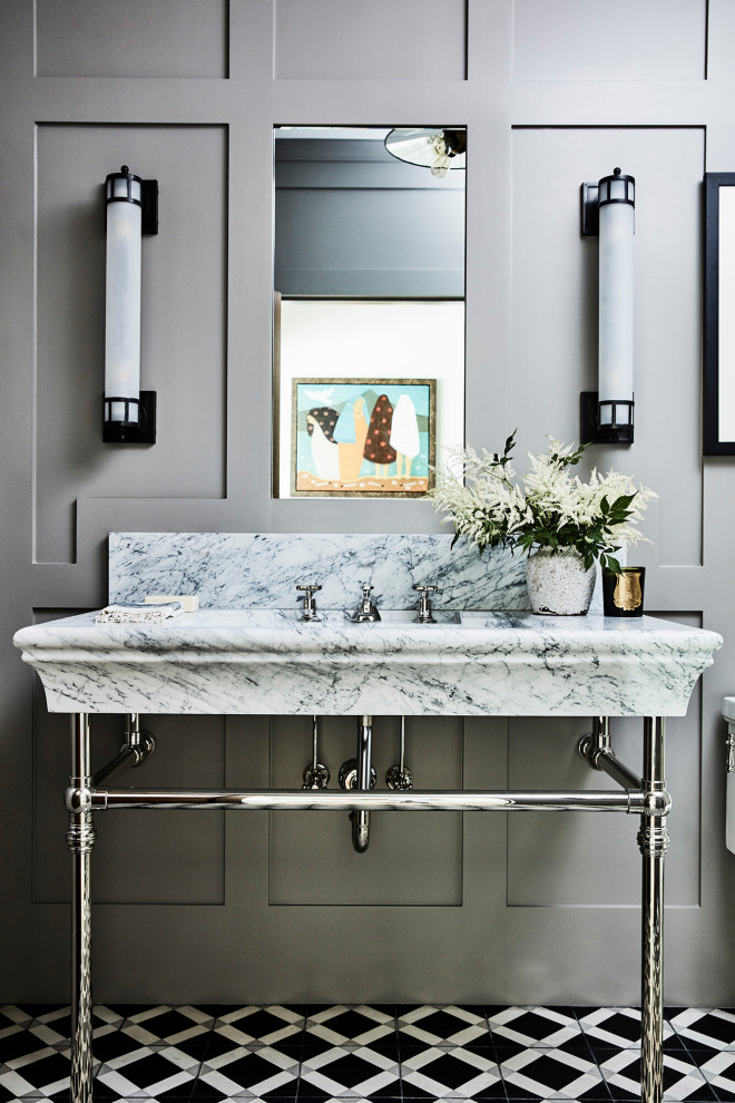 Inspiration for a small beach style powder room in Los Angeles with grey walls, cement tiles, a console sink, black floor, white benchtops, a freestanding vanity and panelled walls.