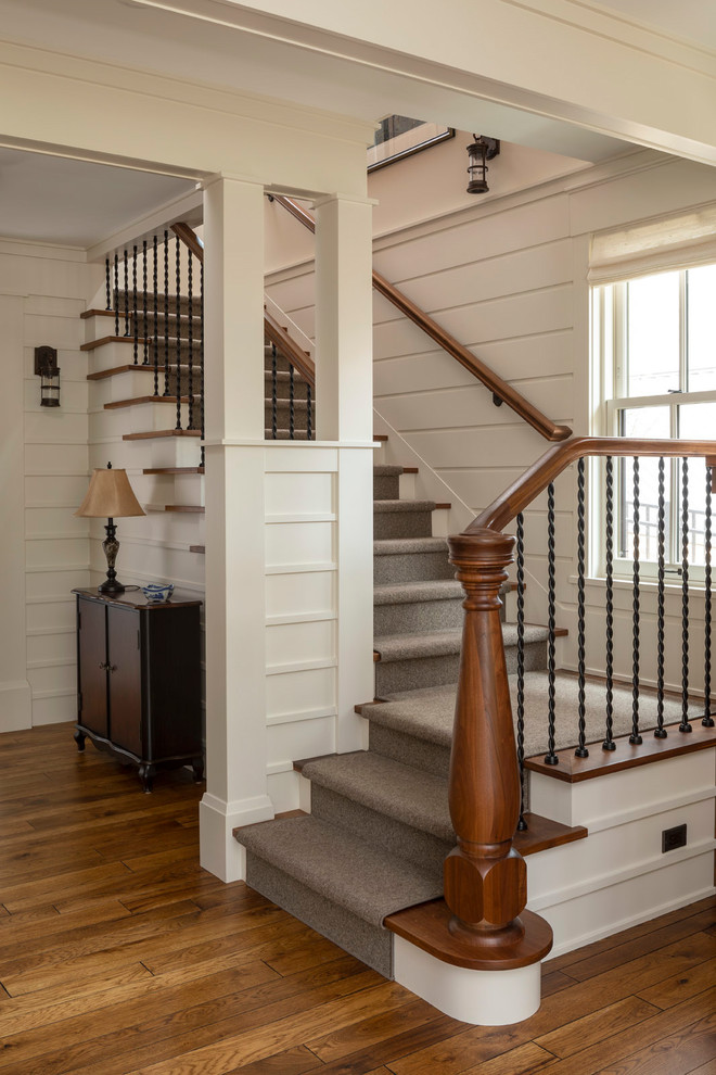 Small traditional carpeted l-shaped staircase in Minneapolis with wood risers and mixed railing.