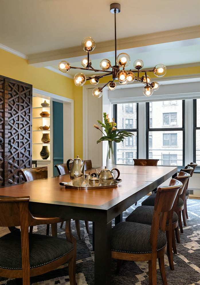 Design ideas for a mid-sized transitional dining room in New York with yellow walls.