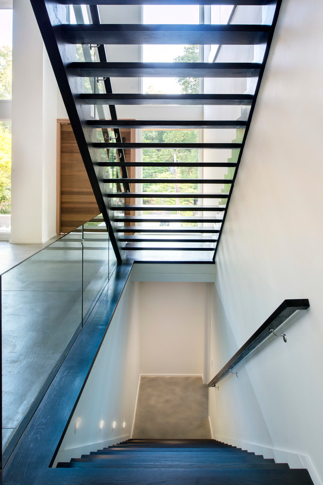 Photo of a mid-sized modern wood straight staircase in Atlanta with open risers.
