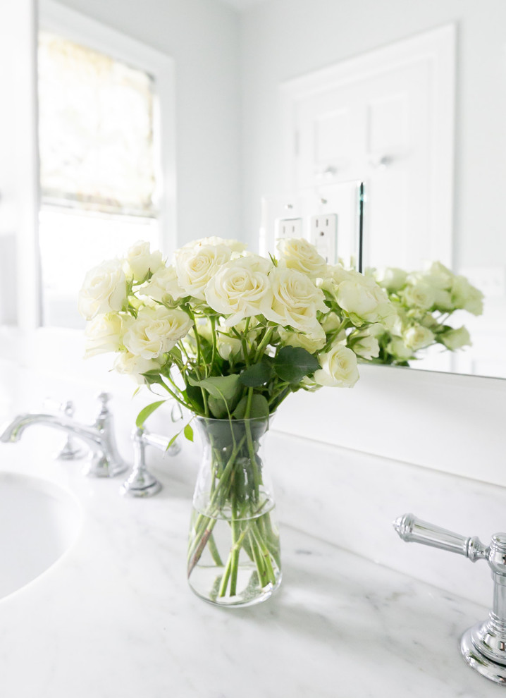 Design ideas for a classic bathroom in Baltimore with white cabinets, a walk-in shower, a two-piece toilet, white tiles, marble tiles, white walls, marble flooring, a pedestal sink, marble worktops, white floors, a hinged door, white worktops, a wall niche, double sinks and wainscoting.