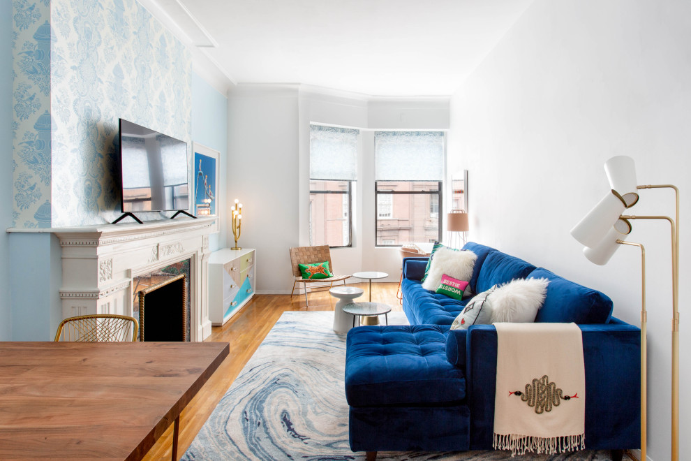 Aménagement d'un salon classique avec un mur bleu, un sol en bois brun, une cheminée standard, un téléviseur indépendant et un sol marron.