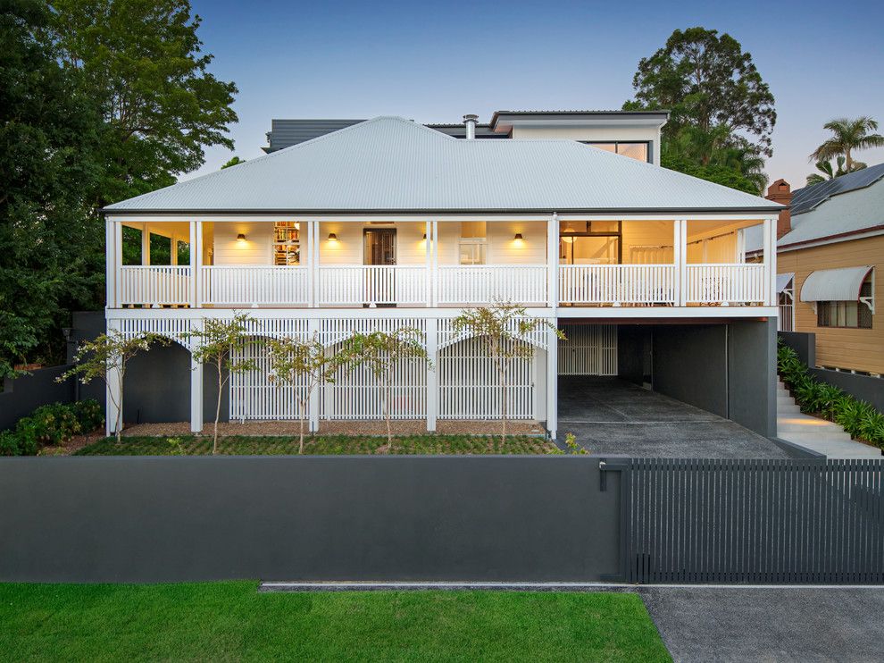Design ideas for an expansive beach style three-storey house exterior in Brisbane.