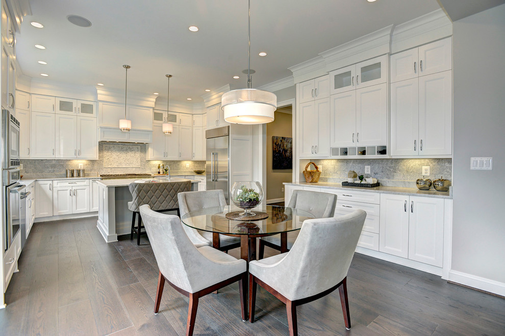 Transitional u-shaped eat-in kitchen in DC Metro with an undermount sink, shaker cabinets, white cabinets, marble benchtops, white splashback, stone tile splashback, stainless steel appliances, dark hardwood floors and with island.