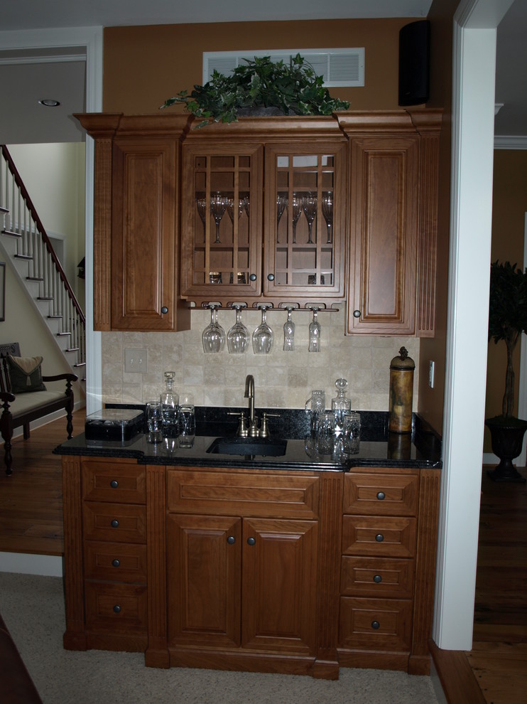 Mid-sized traditional home bar in New York with carpet.