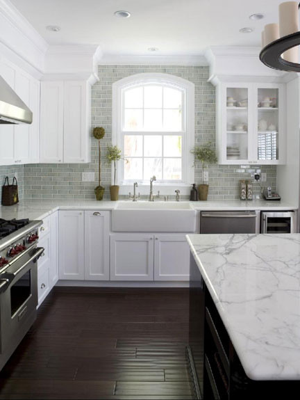 Inspiration for a traditional l-shaped open plan kitchen in San Francisco with a farmhouse sink, shaker cabinets, white cabinets, marble benchtops, ceramic splashback, stainless steel appliances, dark hardwood floors, with island and blue splashback.