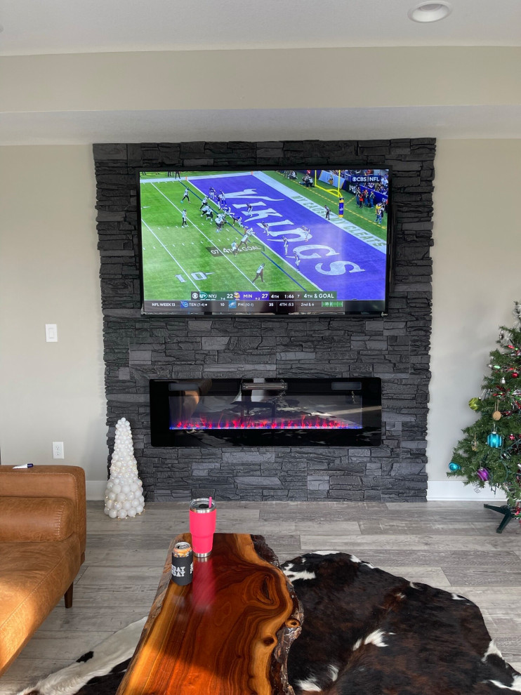 Photo of a living room in Denver with a ribbon fireplace and a wall-mounted tv.